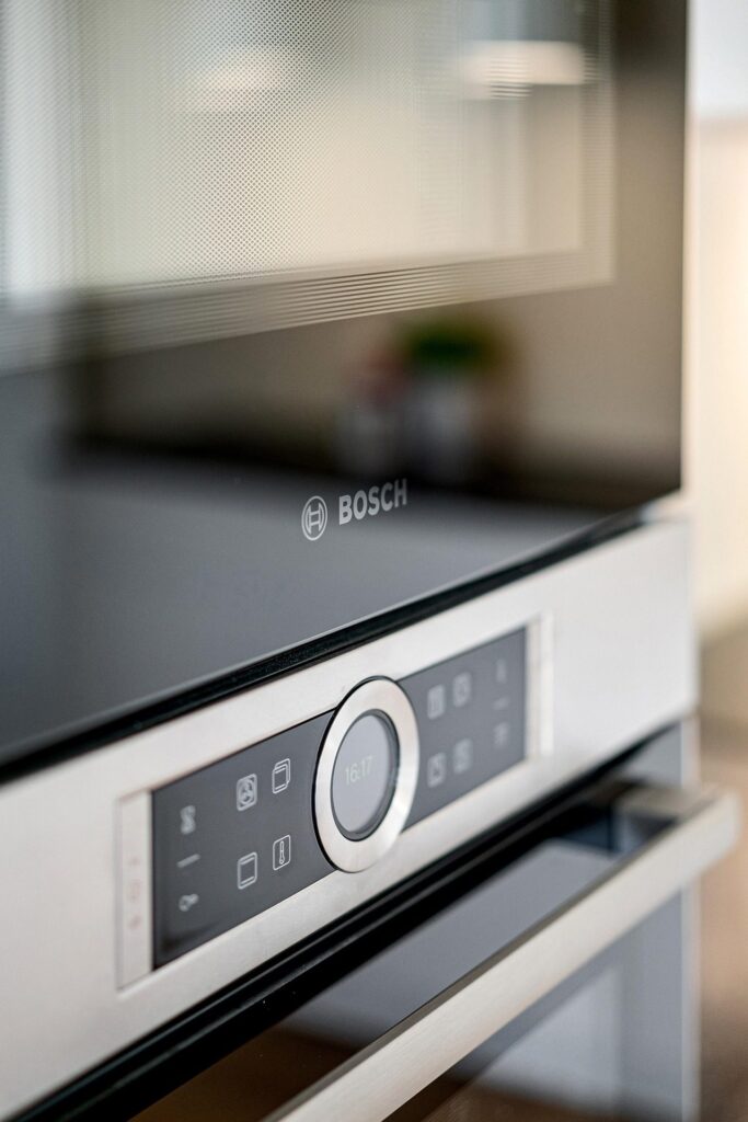 Built-in Bosch wall oven with the glass door and control panel in close-up