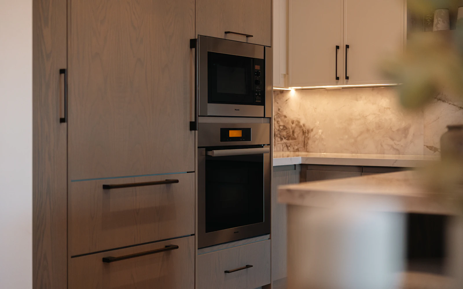 Modern kitchen with a built-in wall oven and microwave